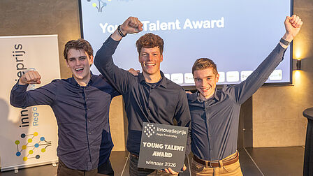 De Young Talent Award ging naar de jonge startup Infaris uit Veenendaa. De drie jonge talenten staan op het podium met bloemen en hun award. 